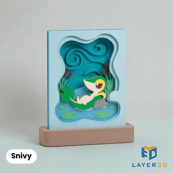 Snivy layered 3D printed shadowbox on a display base, hand-finished desk decor by Layer3D